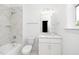 Bathroom featuring tub/shower, white vanity, toilet, and white marble-look tile at 1301 Doylin Dr, Cary, NC 27511