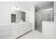 Elegant bathroom featuring double vanity, frameless glass shower, and marble-look tile at 1301 Doylin Dr, Cary, NC 27511
