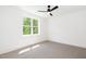 Bedroom with carpet floors, ceiling fan and large window at 1301 Doylin Dr, Cary, NC 27511