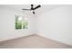 Bright bedroom with ceiling fan, carpet floors, and large window with view at 1301 Doylin Dr, Cary, NC 27511