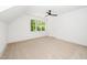 Bright bedroom features a ceiling fan, plush carpeting, and a window offering a serene view at 1301 Doylin Dr, Cary, NC 27511