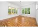 Bright dining room with hardwood floors, large windows, and modern chandelier at 1301 Doylin Dr, Cary, NC 27511