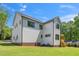 View of the new construction home with black trim, white siding, and a well-maintained green lawn at 1301 Doylin Dr, Cary, NC 27511