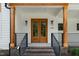 Inviting front entrance featuring elegant wood double doors, stylish lighting and brick stairs at 1301 Doylin Dr, Cary, NC 27511