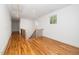 Hallway featuring hardwood floors, stairs and natural light at 1301 Doylin Dr, Cary, NC 27511