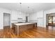 Bright kitchen boasts an oversized island with countertop seating and pendant lighting at 1301 Doylin Dr, Cary, NC 27511