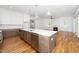 Kitchen featuring an island with sink, marble countertop, stainless dishwasher and view of Gathering room at 1301 Doylin Dr, Cary, NC 27511