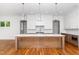 Kitchen island features marble countertops, pendant lighting, and hardwood floors at 1301 Doylin Dr, Cary, NC 27511
