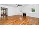 Bright living room with a fireplace, hardwood floors, and a ceiling fan at 1301 Doylin Dr, Cary, NC 27511