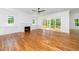 An open-concept living room is designed with hardwood flooring, a fireplace, and sliding glass doors at 1301 Doylin Dr, Cary, NC 27511