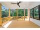 Covered porch with wood flooring and railings overlooks the backyard trees at 1301 Doylin Dr, Cary, NC 27511