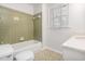 Bathroom with vintage green tiling in the shower/bath and a white vanity at 1324 Swallow Dr, Raleigh, NC 27606
