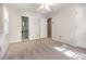 A light-filled bedroom features a ceiling fan, neutral carpet and a small attached bathroom at 1324 Swallow Dr, Raleigh, NC 27606