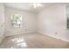 A bright bedroom with neutral carpet, white trim, and bright light from a window at 1324 Swallow Dr, Raleigh, NC 27606