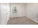 A cozy bedroom features neutral carpet, trim, and paint, plus a large window at 1324 Swallow Dr, Raleigh, NC 27606