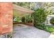 Spacious brick carport leading to the backyard with abundant space for parking and storage at 1324 Swallow Dr, Raleigh, NC 27606