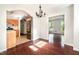 Dining room with gleaming wood floors, contemporary chandelier, open to the kitchen at 1324 Swallow Dr, Raleigh, NC 27606