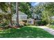 Charming two-story home with lush landscaping, brick accents and a convenient carport at 1324 Swallow Dr, Raleigh, NC 27606
