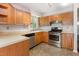 Functional kitchen with stainless steel appliances and light wood cabinets at 1324 Swallow Dr, Raleigh, NC 27606