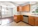 Functional kitchen with stainless steel appliances and light wood cabinets open to the dining area at 1324 Swallow Dr, Raleigh, NC 27606