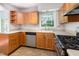 Functional kitchen featuring light wood cabinets, stainless steel appliances, and a window above the sink at 1324 Swallow Dr, Raleigh, NC 27606