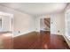 Living room featuring gleaming hardwood floors and neutral paint throughout at 1324 Swallow Dr, Raleigh, NC 27606