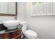 Updated powder room features a vessel sink with a dark vanity and framed mirror at 1324 Swallow Dr, Raleigh, NC 27606