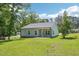 Back exterior featuring light-colored siding, black roof, and a covered porch at 15 Nottingham Pl, Smithfield, NC 27577