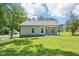 View of the back exterior featuring light-colored siding and a cozy covered porch at 15 Nottingham Pl, Smithfield, NC 27577
