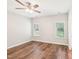 Large bedroom with wood flooring, ceiling fan, and natural light from the room's two windows at 15 Nottingham Pl, Smithfield, NC 27577