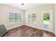 Bright dining area features wood flooring, white trim, and natural light from two large windows at 15 Nottingham Pl, Smithfield, NC 27577