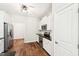 Modern kitchen featuring white cabinets, stainless steel appliances, and hardwood floors at 15 Nottingham Pl, Smithfield, NC 27577