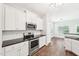Well-lit kitchen features stainless steel appliances and bright white cabinets at 15 Nottingham Pl, Smithfield, NC 27577