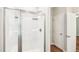 Walk-in shower featuring glass doors, a built-in shower caddy, and is well-lit at 15 Nottingham Pl, Smithfield, NC 27577