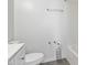 A clean and simple bathroom features a toilet and toilet paper holder next to a shower-tub combo at 1508 Malta Ave, Raleigh, NC 27610