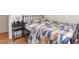 This bedroom features a bed with a patterned comforter, wood flooring, and black bedside table at 1508 Malta Ave, Raleigh, NC 27610