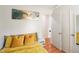 Cozy bedroom with a gold bed, a side table, and an open doorway to a well lit interior at 1508 Malta Ave, Raleigh, NC 27610