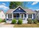 Charming blue home featuring a cozy front porch and white trim details at 1508 Malta Ave, Raleigh, NC 27610