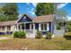 Charming blue home featuring a cozy front porch and white trim details at 1508 Malta Ave, Raleigh, NC 27610