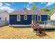 Back exterior of a charming blue home with a wood deck and a grassy lawn at 1508 Malta Ave, Raleigh, NC 27610