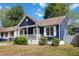 Charming blue home featuring a cozy front porch and white trim details at 1508 Malta Ave, Raleigh, NC 27610
