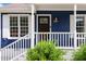 Inviting front porch with a dark-stained front door and white railing at 1508 Malta Ave, Raleigh, NC 27610