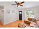 Bright living room with a large window and comfortable leather sectional couch at 1508 Malta Ave, Raleigh, NC 27610