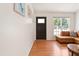 Bright living room with a large window and comfortable leather sectional couch at 1508 Malta Ave, Raleigh, NC 27610