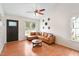 Bright living room with vaulted ceilings, a fan, and comfortable leather sectional couch at 1508 Malta Ave, Raleigh, NC 27610