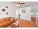 Open living room with natural light, ceiling fan and a comfortable leather sofa at 1508 Malta Ave, Raleigh, NC 27610