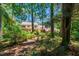 Mature wooded lot behind a brick and vinyl home gives natural privacy at 1604 Westbridge Ct, Raleigh, NC 27606