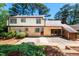Brick and vinyl home with a large patio and landscaped yard at 1604 Westbridge Ct, Raleigh, NC 27606