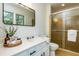 Well-lit bathroom with a white vanity, a toilet, and a shower with a glass door at 1604 Westbridge Ct, Raleigh, NC 27606
