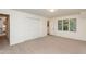 Spacious bedroom features neutral carpet, a closet, and a window with green tree views at 1604 Westbridge Ct, Raleigh, NC 27606